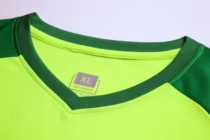 Close-up of a lime green goalkeeper jersey neckline showing the size XL label