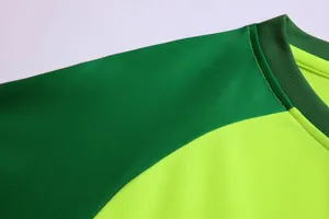 Close-up detail of the green breathable mesh fabric on a soccer goalkeeper jersey