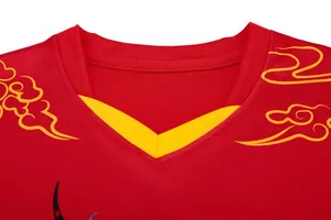 Close-up of the yellow V-neck collar and dragon print on the red dragon boat jersey