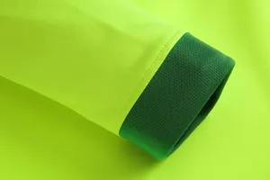 Close-up of neon green goalkeeper jersey sleeve with dark green ribbed cuff detail