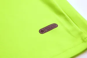 Detailed macro view of neon goalkeeper jersey mesh fabric and official licensed label
