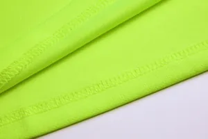 Detailed macro shot of reinforced stitching on neon green goalkeeper jersey fabric
