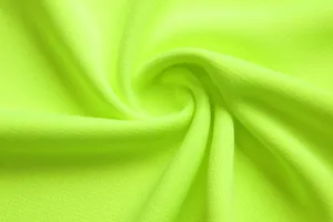Detailed close-up view of vibrant neon green breathable mesh fabric for soccer jersey