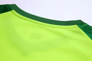 Detailed view of the breathable mesh neckline on a lime green soccer goalie jersey