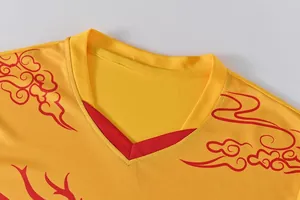 Close-up of the V-neck on a yellow quick-dry dragon boat jersey with red dragon pattern