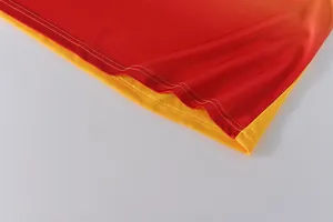 Close-up view of durable double-stitched hem on quick-dry red and yellow dragon boat jersey