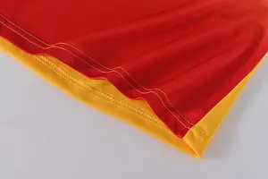 Close-up of double-stitched hem on a red and yellow quick-dry dragon boat jersey