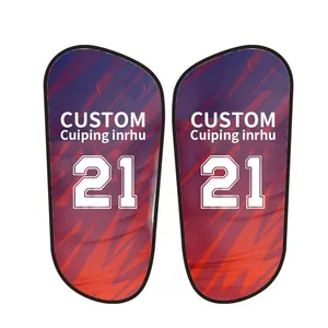 Detail view of customized football shin guards with abstract red and blue patterns.