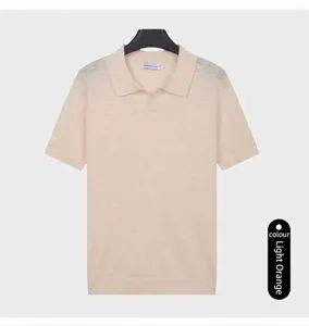 Detail view of a light orange short sleeve knitted polo shirt with a classic collar