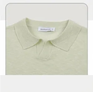 Close-up of the elegant seagull collar design on sage green knitted men's polo shirt