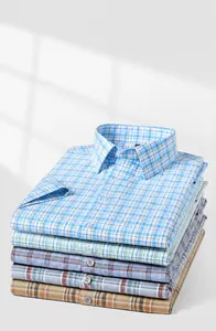 Close-up of folded 100% cotton short-sleeved plaid oxford shirts in various colors
