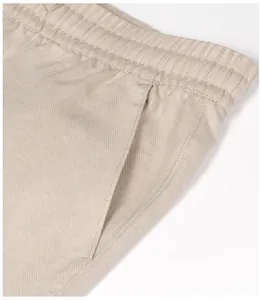 Close-up detail of herringbone texture on beige breathable linen blend men's casual pants