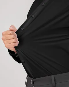 Détail de la chemise noire à manches longues extensible montrant l'élasticité du tissu