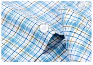 Close-up detail of the durable button placket on a blue and white plaid cotton shirt