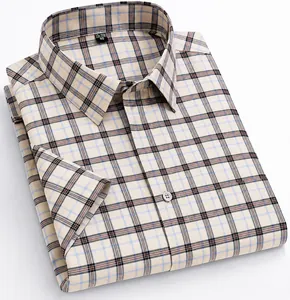 Detailed view of a folded beige plaid short-sleeve shirt crafted in 100% pure cotton.