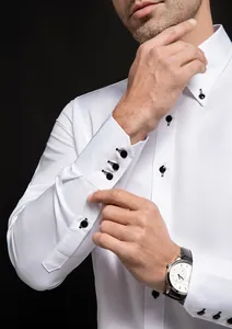 Detailed view of white men's business shirt with stylish black diamond buttons
