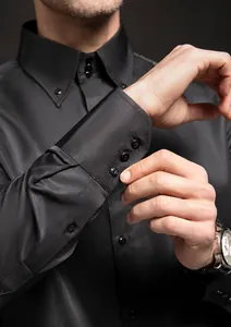 Close-up of black business shirt cuff featuring elegant diamond-style buttons