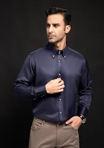 Detail of premium men's navy blue long-sleeve business shirt featuring diamond buttons