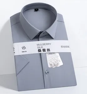 Detail shot of a folded grey short-sleeve shirt with mulberry silk packaging