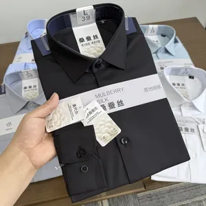 Detail shot of a black mulberry silk and modal blend men's shirt showing fabric texture.