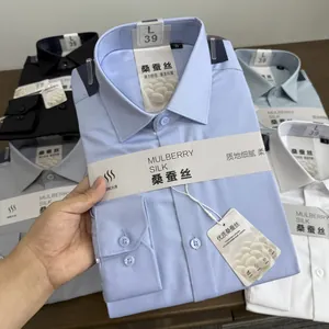 Detailed macro view of folded mulberry silk blend men's dress shirts with product tags