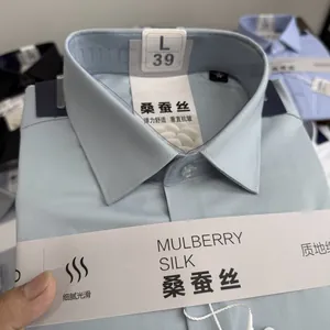 Detail view of light blue mulberry silk blend shirt with premium fabric labels