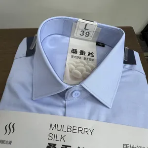 Close-up detail of a light blue mulberry silk blend men's dress shirt collar.