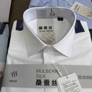 Detailed view of white mulberry silk blend men's shirt collar and quality labels.