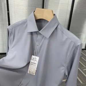 Detailed view of a light blue silk and modal blend men's dress shirt on a hanger