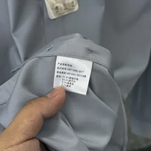 Close-up of the wash care label showing material composition of silk and modal blend shirt