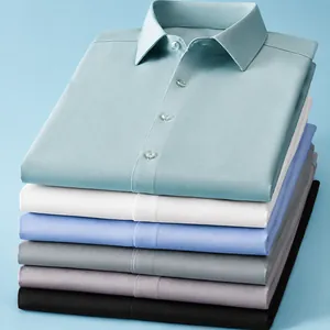 Stack of colorful men's silk and modal short sleeve business shirts on blue background
