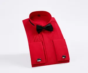 Detailed view of red tuxedo shirt with wing collar, black bow tie, and French cuffs