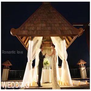 Formal evening wear for men and women in a romantic outdoor wedding gazebo setting