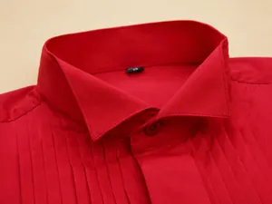 Close-up view of a vibrant red formal tuxedo shirt collar featuring elegant pleated details