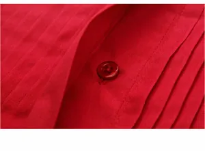 Close-up detail of a red tuxedo shirt showing the button and pleated fabric