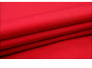 Macro detail shot showing the breathable red textile texture of the formal tuxedo dress shirt