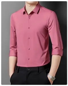 Detailed view of dark pink long-sleeve men's dress shirt with clean seams and buttons.