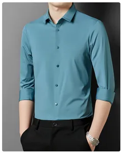 Detail view of a men's turquoise long-sleeve business casual shirt with non-iron fabric.