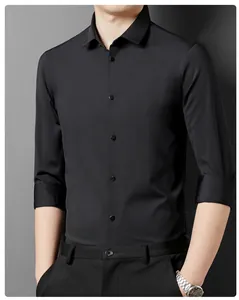 Close-up of a slim-fit black men's business shirt with rolled-up sleeves.