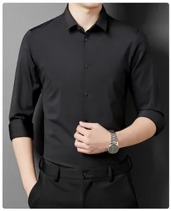 Close-up detail of black non-iron business casual long sleeve shirt worn by a male model