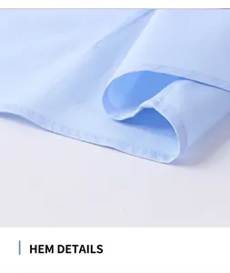 Macro view of the finely stitched hem of a light blue women's cotton shirt