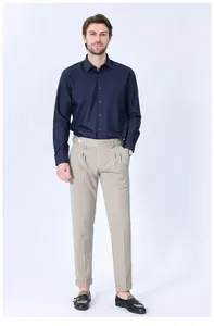 Professional man wearing a navy blue long-sleeved modal shirt paired with beige trousers