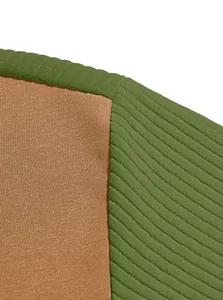 Detailed macro view of green ribbed and brown smooth knit fabric textures on a garment.