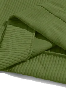 Close-up of premium olive green ribbed knit fabric showing durable seam stitching details