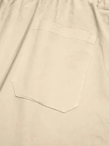 Detailed close-up of the stitched pocket on these beige men's linen casual pants