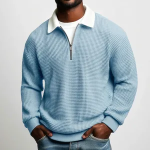 Detailed macro view showing the light blue waffle knit fabric texture and silver zipper polo collar