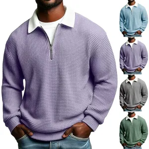Detail view of men's waffle knit quarter-zip sweater showing multiple color variants