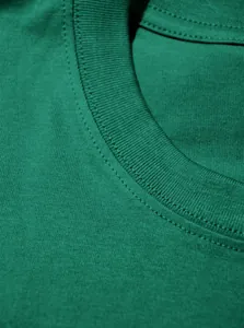 Détail en gros plan d'un col de t-shirt en coton vert avec des coutures de qualité