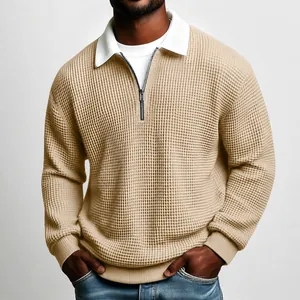 Detailed view of khaki waffle knit sweatshirt featuring a zip-up collar and ribbed cuffs.