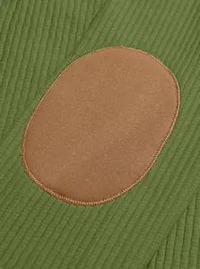 Macro detail view showing the green ribbed knit fabric and brown oval elbow patch design